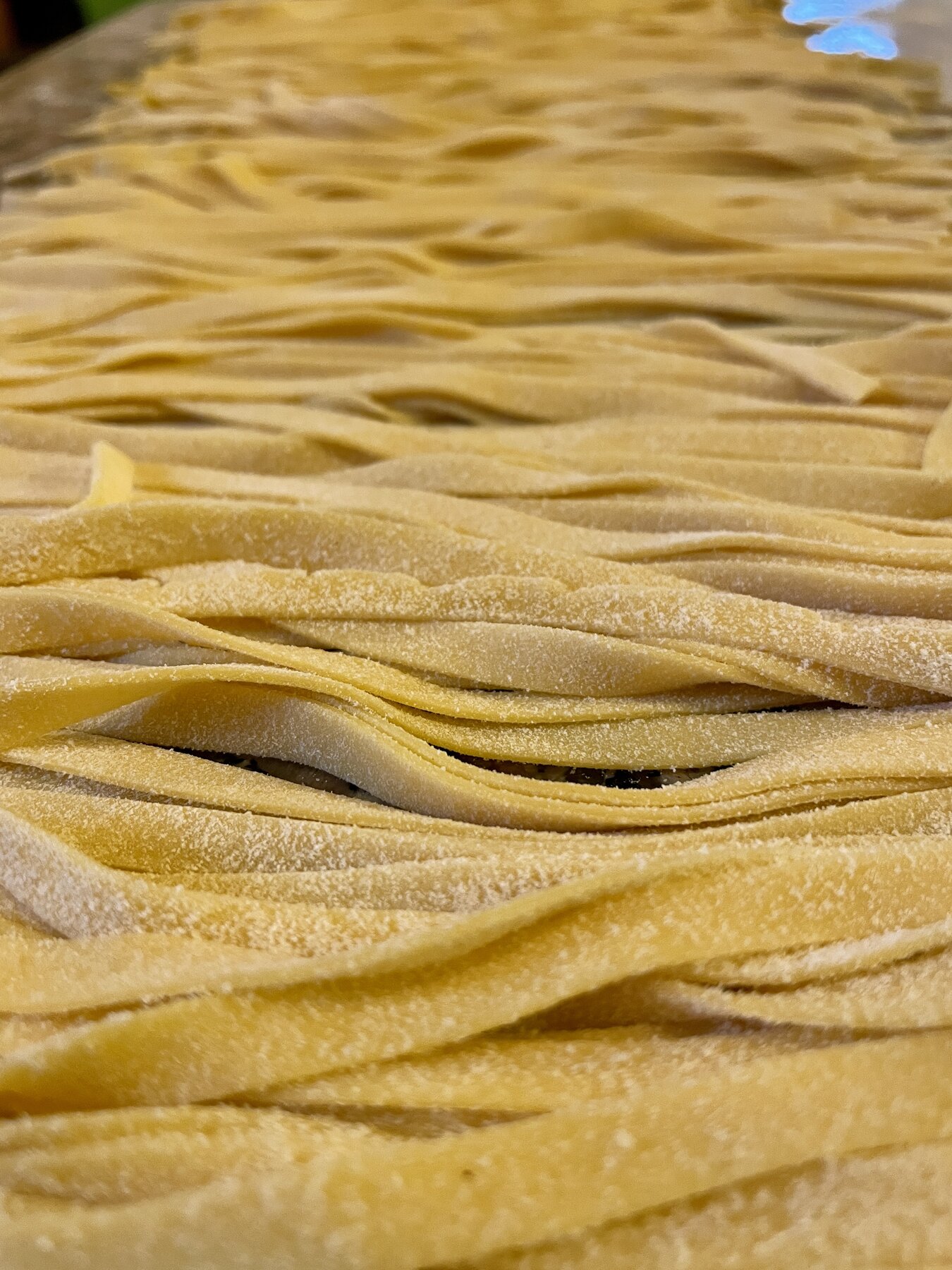 Fresh pasta sheets being cut