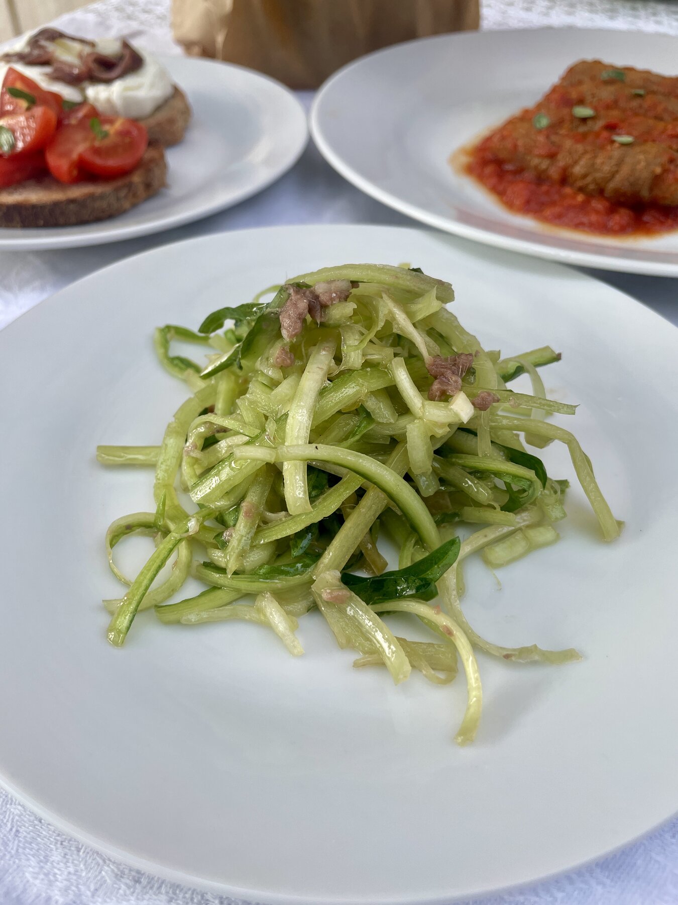 Roman vegetable salad with bruschetta and involtini in the background